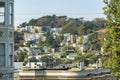 Sprawling city on a sunny hill with modern house foreground in shade with trees and rooftops in San Francisco California Royalty Free Stock Photo