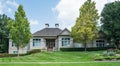 Sprawling Gray Stucco Ranch Home with Wood and Glass Door Royalty Free Stock Photo