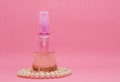 A spray bottle filled with liquid and a pearl necklace Royalty Free Stock Photo