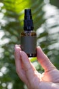 Spray Bottle in Hand Amidst Lush Greenery Royalty Free Stock Photo