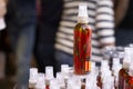 Spray bottle with organic olive oil with red hot chilli pepper on the market showcase. Spain, Catalonia, Barcelona 2019