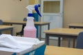 A spray bottle and paper towels on an office or school desk for cleaning and sanitization concepts for COVID-19 coronavirus