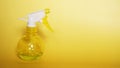 Spray bottle on yellow background. Portable pressure water sprayer pump