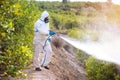 Spray ecological pesticide. Farmer fumigate in protective suit and mask lemon trees. Man spraying toxic pesticides, pesticide, Royalty Free Stock Photo