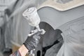 Spray gun. Worker painting parts of the car in special painting chamber, wearing costume and protective gear. Car Royalty Free Stock Photo