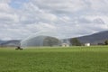 Spray Irrigator with Farm House in Background
