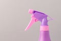 Spray nozzle on a bottle/purple spray nozzle on a bottle on a grey background. Copy space