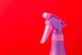 Spray nozzle on a bottle/purple spray nozzle on a bottle on a red background