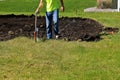 Spray painting white line determining construction footing boundaries