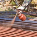 Spray red color to paint the roof of a building Royalty Free Stock Photo