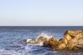 A spray of restless waves beating on stones