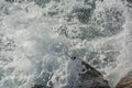 A spray of water. Waves break on coastal rocks and turn into spray Royalty Free Stock Photo