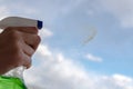 The sprayer disperses window cleaner onto the surface of dirty glass Royalty Free Stock Photo