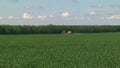 Sprayer on green wheat field contributes crop protection products