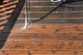 Cleaning a deck with water pressure Royalty Free Stock Photo