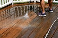 Cleaning a deck with water pressure Royalty Free Stock Photo