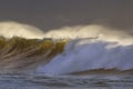 Spraying breaking waves at sunset