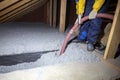 Spraying cellulose insulation in the attic of a house. Insulation of the attic or floor in the house