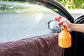 Spraying soapy solution removing old car window film tint Royalty Free Stock Photo