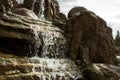 Spraying stream waterfall Splashing mountain water in motion. Tropical rocks and stones. Water motion from the cascade is