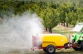 Spraying trees in fruit orchard