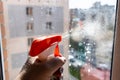 spraying washing liquid on surface of window glass Royalty Free Stock Photo