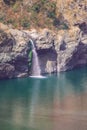 Water running over brown rocks like small waterfall Royalty Free Stock Photo