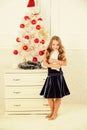 Spread christmas cheer. Kid cheerful excited about new year coming. Small girl wear velvet dress feels festive near Royalty Free Stock Photo