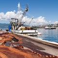 Spread fishing nets, fishing boat on dock Royalty Free Stock Photo