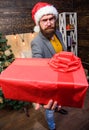 Spread happiness and joy. Bearded guy with eyeglasses carry present box. Delivery christmas present. Delivery service