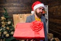 Spread happiness and joy. Bearded guy with eyeglasses carry present box. Delivery christmas present. Delivery service