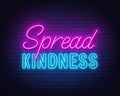 Spread Kindness neon lettering on brick wall background.