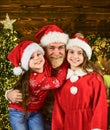 Spread love around. Father and little daughters celebrate new year. Christmas becomes special with children. Christmas
