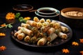a spread of spring rolls and a pair of chopsticks resting on a black plate Royalty Free Stock Photo