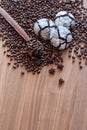 Spread on a wooden table coffee beans with spices with three cakes