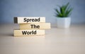 Spread the word word written on wood block. Spread the word text on table, concept