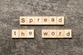 Spread the word word written on wood block. Spread the word text on table, concept