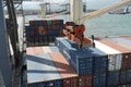 Spreader of gantry crane operated by stevedores approaching container to unload it from a ship. Royalty Free Stock Photo