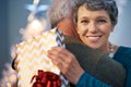 Spreading the love at christmas. Portrait of a mature woman thanking her partner for her christmas present with a hug.