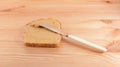 Spreading peanut butter onto a slice of bread Royalty Free Stock Photo