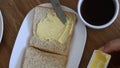 Spreading Vegan Butter On Rye Bread Without Dairy And Eggs with cup of coffee. Closeup. Royalty Free Stock Photo