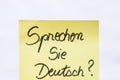 Sprechen sie deutsch do you speak german handwriting text close up isolated on yellow paper with copy space
