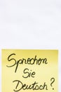 Sprechen sie deutsch do you speak german handwriting text close up isolated on yellow paper with copy space