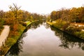 Spree river channel in Berlin during Autumn with fallen leaves on the ground