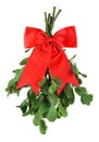 Sprig of fresh green mistletoe tied with bright red Christmas bow. Isolated on white