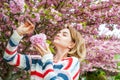 Spring allergy. Beautiful woman enjoying nature blooming tree.