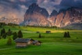 Spring alpine landscape and wooden chalets on the fields, Dolomites Royalty Free Stock Photo