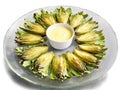 Spring appetizer artichoke hearts with lemon aioli served on a transparent glass plate tender