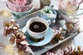 Spring apple blossoms and a cup of black coffee in a tray on blue wooden table Royalty Free Stock Photo