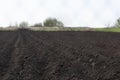 Spring arable land on a farm with black soil, fertile soil of the agro complex Royalty Free Stock Photo